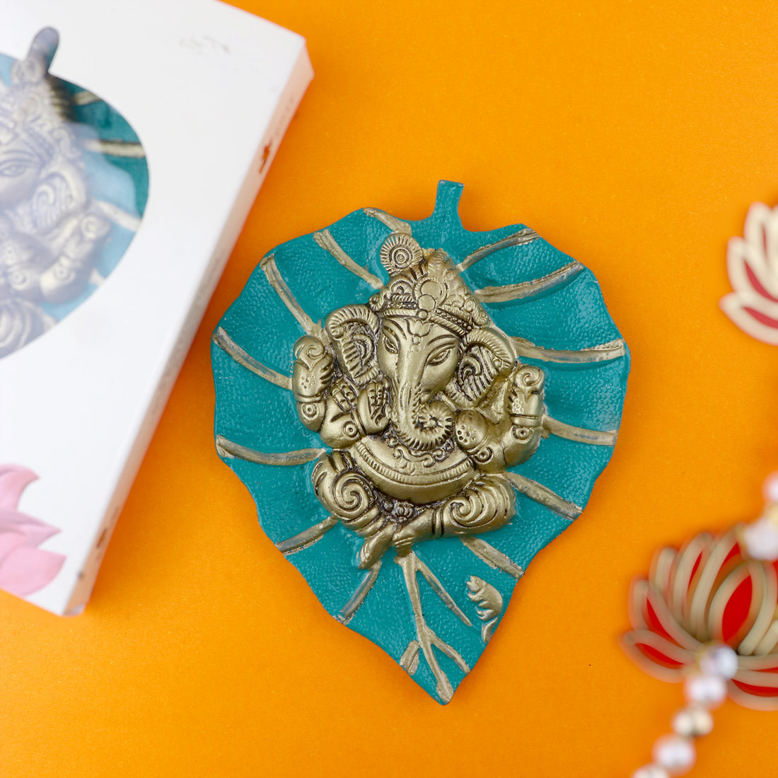 Green wall hanging featuring Lord Ganesh seated gracefully on a carved leaf (patta) design, perfect for adding spiritual charm to any space. India’s Largest Pooja Accessories Brand – www.satvikstore.in