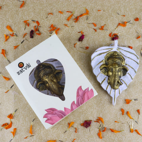 1 Pc Lord Ganesh Face on Leaf Patta Wall Hanging White β Elegant white wall decor featuring Lord Ganeshaβs face embossed on a leaf-shaped patta for serene and spiritual home ambiance. Indiaβs Largest Pooja Accessories Brand β www.satvikstore.in