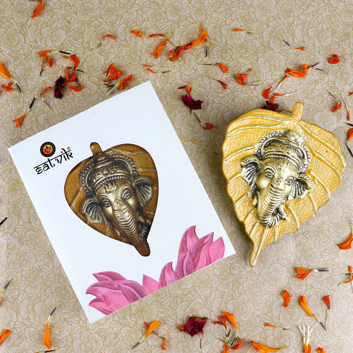 1 Pc Lord Ganesh Face on Leaf Patta Wall Hanging Yellow – Vibrant yellow leaf-shaped wall decor featuring Lord Ganesha’s face for traditional and spiritual home decoration. India’s Largest Pooja Accessories Brand – www.satvikstore.in