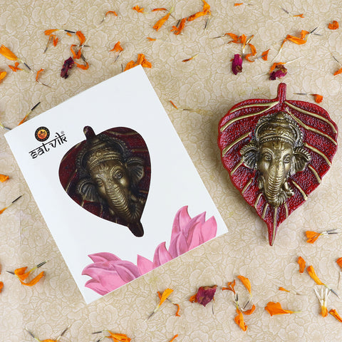 1 Pc Lord Ganesh Face on Leaf Patta Wall Hanging β A beautifully crafted decorative piece featuring Ganesh ji's face on a leaf-shaped patta for spiritual home decor. Indiaβs Largest Pooja Accessories Brand β www.satvikstore.in