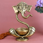Alluring Brass Ganesh Akhand Diya featuring a detailed idol of Lord Ganesha with an attached eternal flame oil chamber, perfect for long-lasting spiritual glow during pooja, festivals, and daily worship. India’s Largest Pooja Accessories Brand – www.satvikstore.in