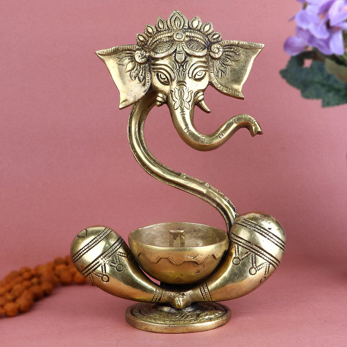 Alluring Brass Ganesh Akhand Diya featuring a detailed idol of Lord Ganesha with an attached eternal flame oil chamber, perfect for long-lasting spiritual glow during pooja, festivals, and daily worship. India’s Largest Pooja Accessories Brand – www.satvikstore.in