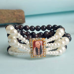 Black with White Pearl Four Layer Guruji Swaroop Bracelet featuring elegant black beads accented with luminous white pearls and Jai Guruji Swaroop – perfect for spiritual wear, festive gifting, and daily devotion. India’s Largest Pooja Accessories Brand – www.satvikstore.in
