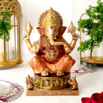 8.7 Inch Brass Idol of Colored Brass Ganesh Statue. Enhance your home with the vibrant charm of this Colored Brass Ganesh Statue, a perfect fusion of tradition and artistry. Crafted from high-quality brass and adorned with vivid hand-painted colors, this exquisite idol beautifully represents Lord Ganesha, the remover of obstacles and symbol of prosperity.  India's Largest Puja Accessories Brand - Satvik