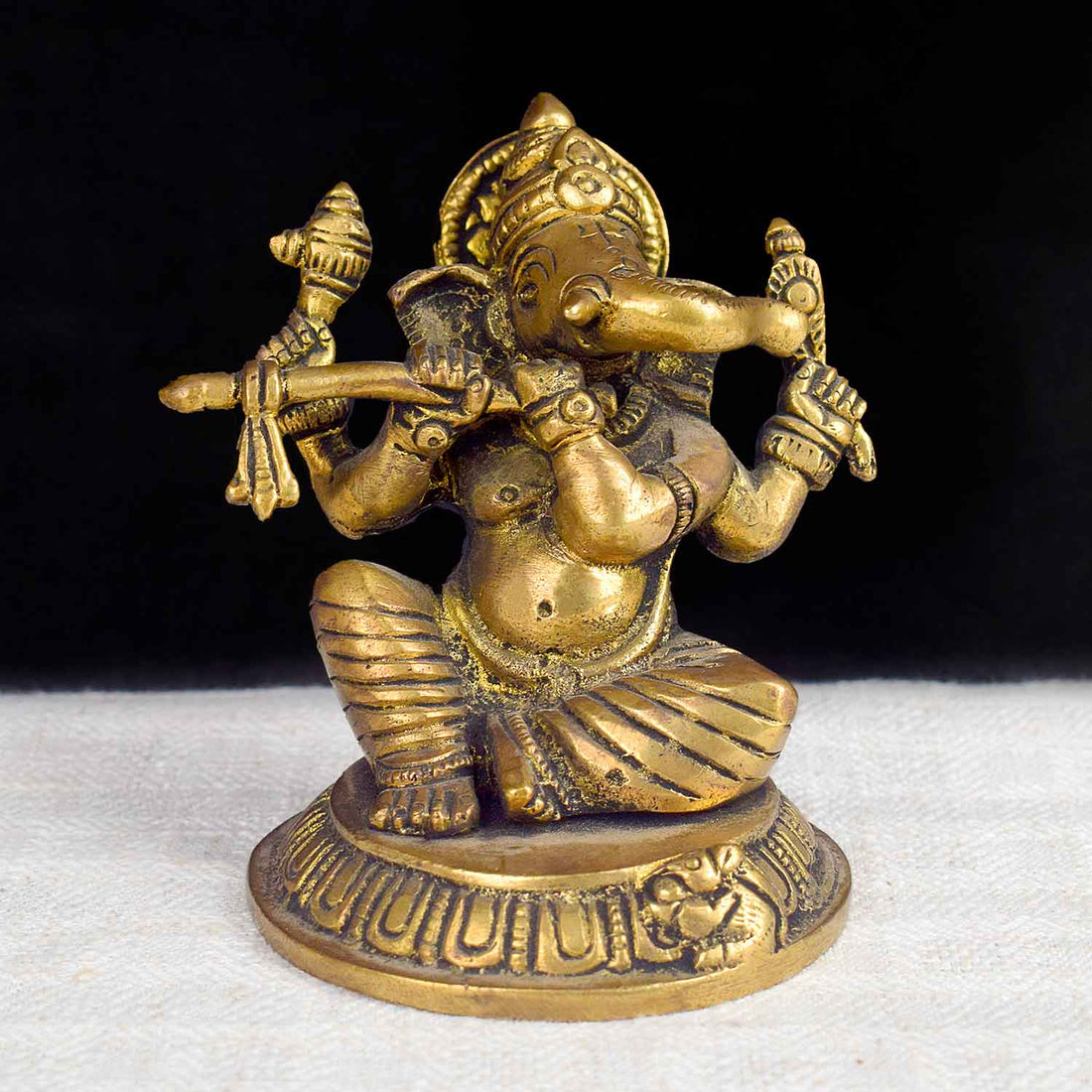 3.1 Inch Divine Brass Ganesha Statue playing flute, beautifully crafted with serene expression and traditional detailing – ideal for spiritual décor, gifting, and festive worship. No.1 Brass Idol Store www.satvikstore.in 
