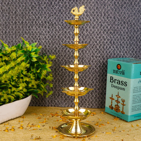 Brass 5 Step Peacock Kerala Diya – Handcrafted brass diya with a five-step structure and peacock design, perfect for pooja rituals, temple lighting, and traditional décor. India’s Largest Pooja Accessories Brand – www.satvikstore.in